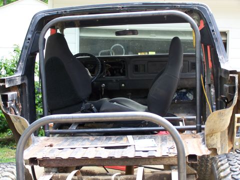 1979 Ford F-150 - This 1979 Ford F-150 shows extensive modifications, including a roll cage and racing seats, suggesting off-road or custom use.