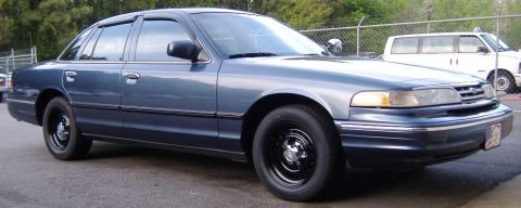 1996 Ford Crown Victoria - A blue 1996 Ford Crown Victoria sedan is shown from the front three-quarter angle.