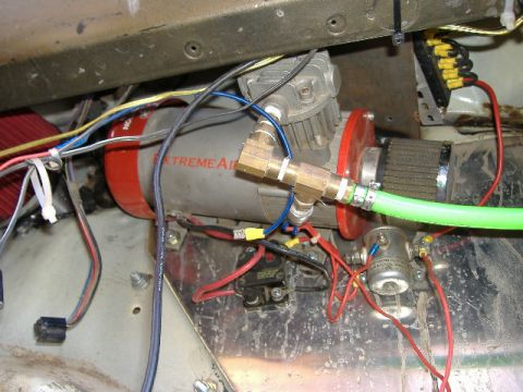 1979 Ford Bronco - Vehicle interior shows an Extreme Air compressor with associated wiring and plumbing components.