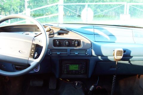 1993 Ford Taurus - Interior view of a 1993 Ford Taurus, showing the dashboard, steering wheel, and aftermarket radio.