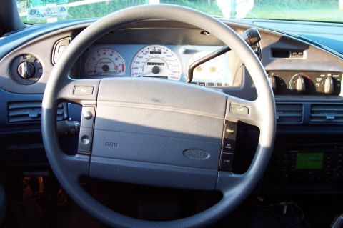 1993 Ford Taurus - The interior of a 1993 Ford Taurus shows the dashboard, steering wheel, and instrument cluster.