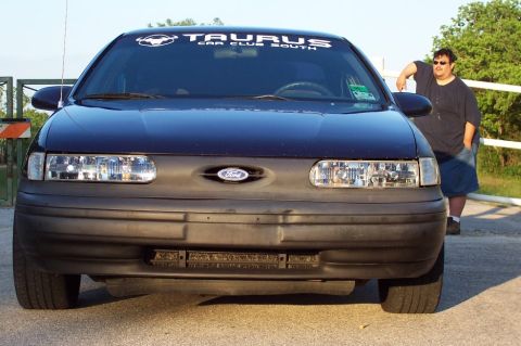 1993 Ford Taurus - A dark blue 1992 Ford Taurus is shown from the front, with a man standing next to it.