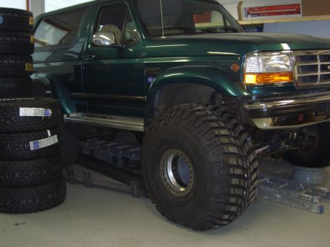 1996 Ford Bronco - Green 1996 Ford Bronco parked indoors next to a stack of tires.