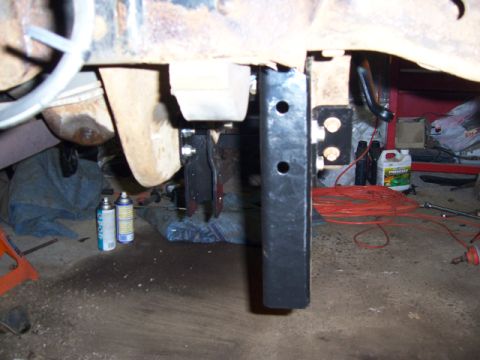1996 Ford Bronco - Close-up view of a vehicle's undercarriage, showing suspension modifications and tools.