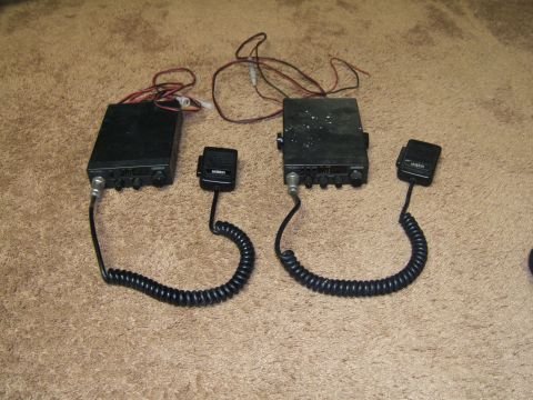 1998 Ford Taurus - Two Uniden CB radios and their microphones are displayed on a carpeted floor.