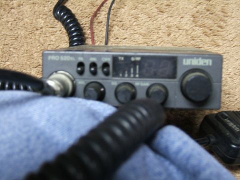 1998 Ford Taurus - A Uniden PRO 520XL CB radio is shown with its microphone and coiled cord, resting on a carpeted surface.