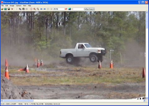 1989 Ford Bronco - Pickup truck mid-air during an obstacle course event.