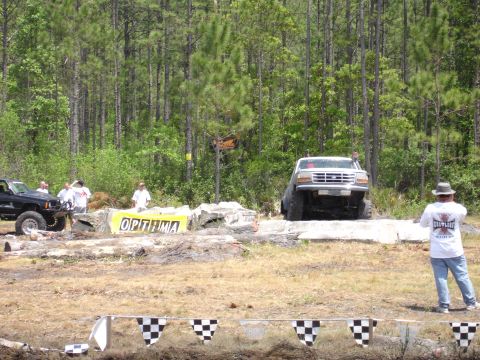 1989 Ford Bronco - Ford Bronco tackles a challenging off-road course, with another vehicle visible in the background.