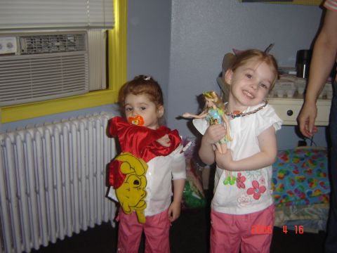 1993 Ford Bronco - Two young girls are posing for a photo indoors, one dressed as Winnie the Pooh and the other holding a doll.