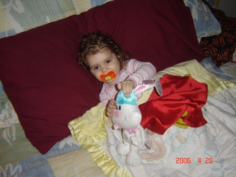 1993 Ford Bronco - A young child lies in bed with a pacifier and a stuffed bunny toy.