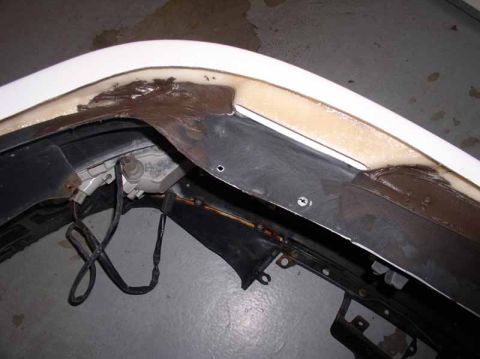 1996 Ford Probe - Close-up view of a disassembled front bumper assembly, showing internal components and wiring.