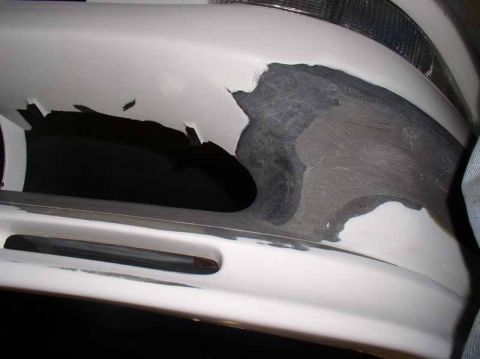 1996 Ford Probe - Bumper repair in progress, showing body filler and damaged paint.