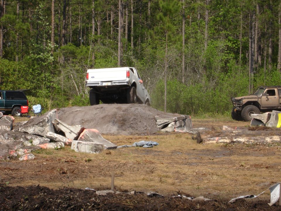 White pickup truck's rear view on dirt mound
