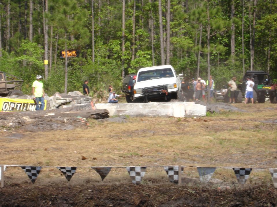 White pickup truck navigating an obstacle course