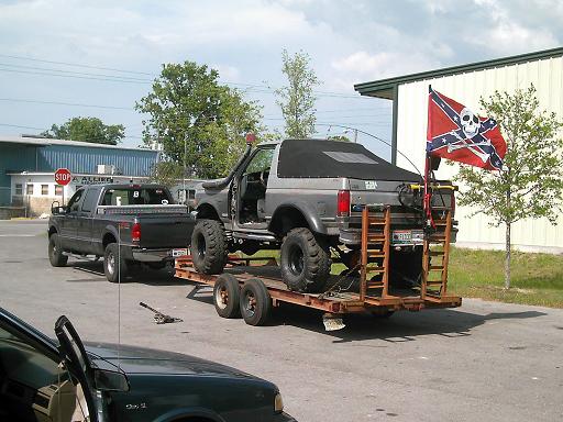 1986 Ford Bronco on trailer, rear view, lifted with soft top