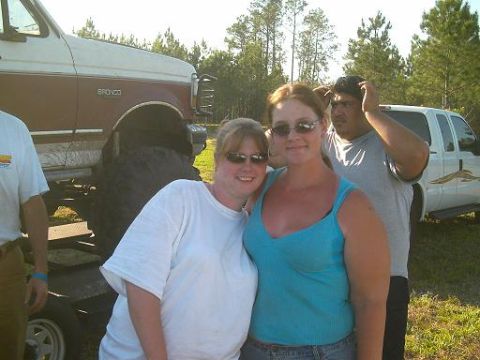1986 Ford Bronco - A group of people gathered outdoors with a lifted Ford Bronco and another SUV visible in the background.