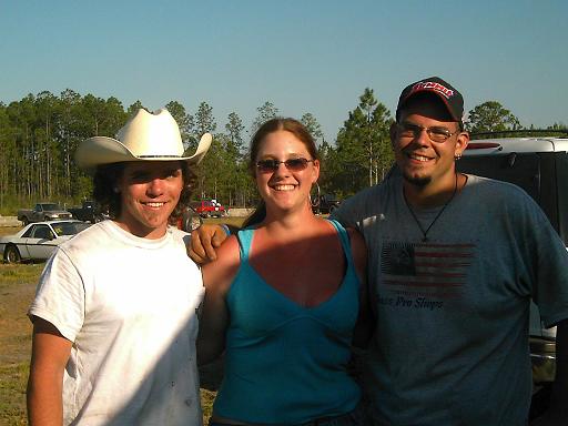 guy in cowboy hat, woman in blue tank top, guy in baseball cap and t-shirt with flag graphic