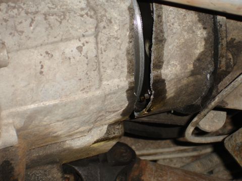 1989 Ford Bronco - Transmission housing shows significant damage and fluid leaks.