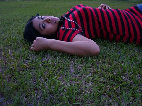 1994 Ford Probe - A person rests on a grassy field, their gaze directed towards the viewer.