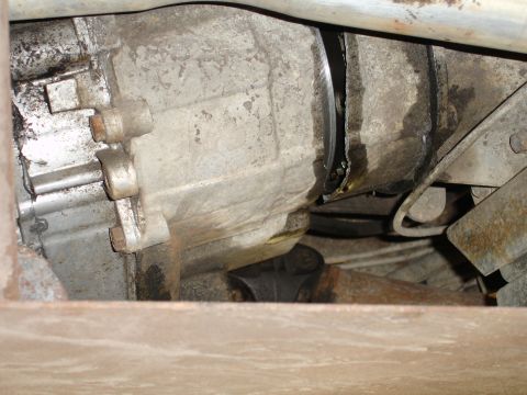 1989 Ford Bronco - Close-up view of a damaged transmission housing, showing signs of an oil leak.