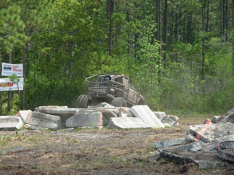 Off-road vehicle with roll cage navigating concrete obstacles