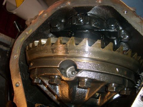 1990 Ford Bronco - Differential gear assembly showing the ring gear and internal components, with some stamped markings.