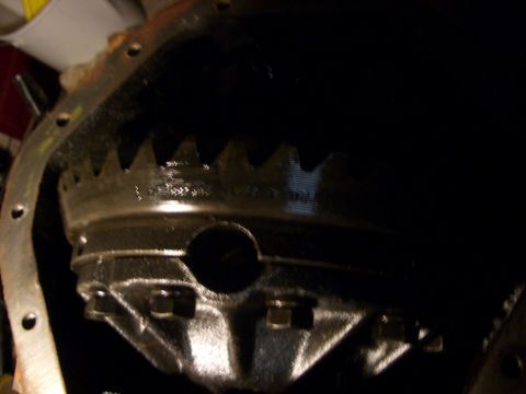 1990 Ford Bronco - A close-up view of a differential gear, possibly from a truck or SUV, showing its teeth and housing.