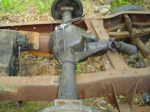 1979 Ford Bronco - Close-up view of the rear axle and drivetrain components of a vehicle chassis.