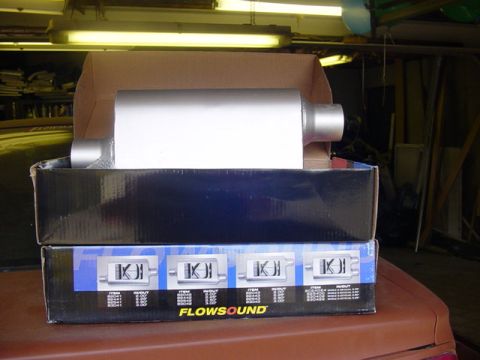 1995 Ford Mustang - A new Flowsound exhaust muffler is shown in its packaging, ready for installation.