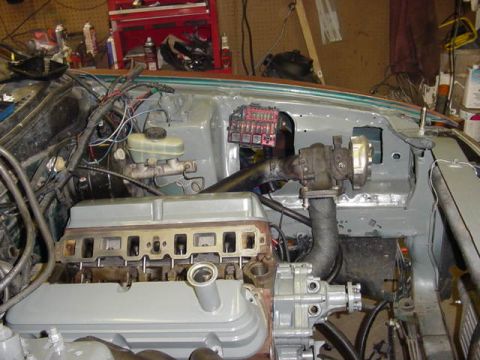 1995 Ford Mustang - Engine bay components including a turbocharger, brake fluid reservoir, and fuse box are shown.