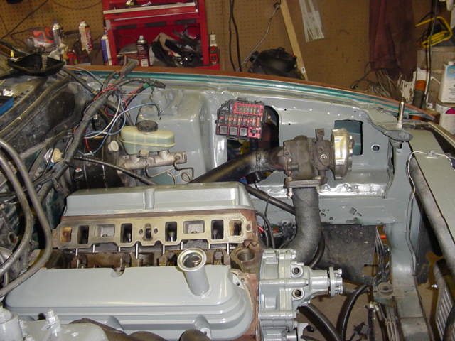 Engine bay with a turbocharger installed, brake fluid reservoir, and fuse box visible