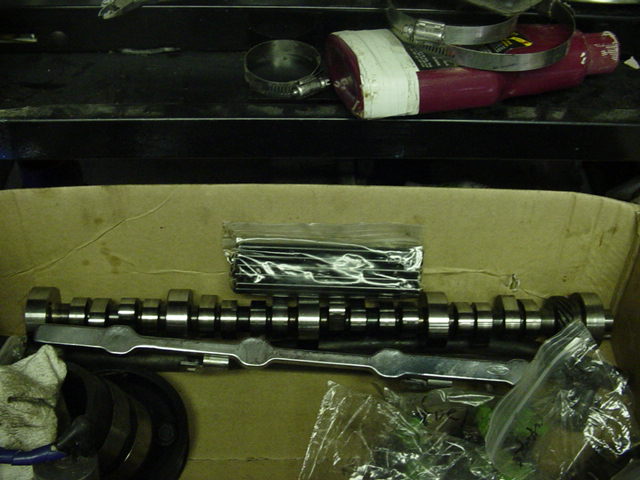 Camshaft and assorted engine parts in a box