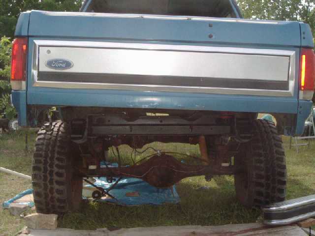 Driver's side raised with jack, rear frame painted