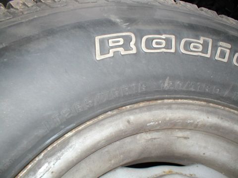 1979 Ford Bronco - Close-up of a tire and wheel assembly, showing tire size and brand markings.