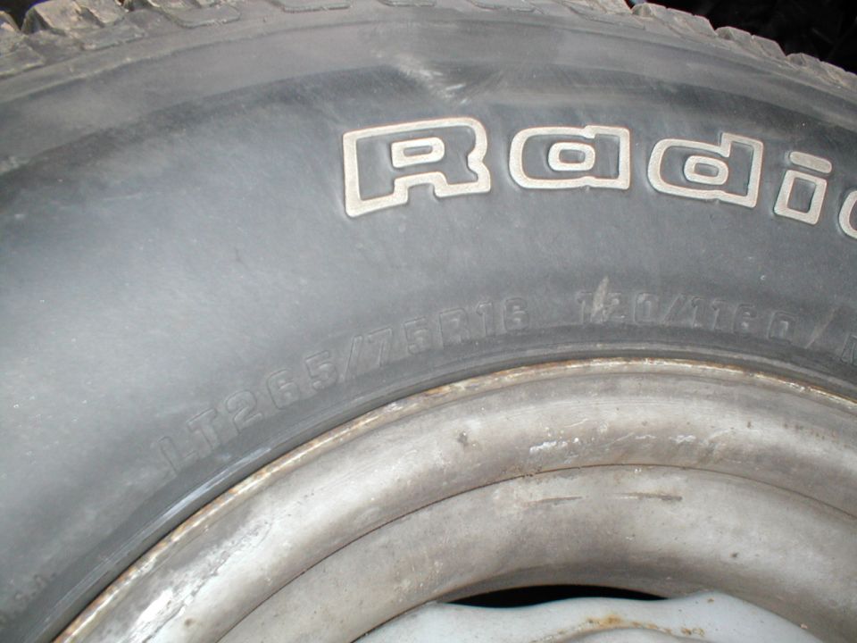 Tire with raised white lettering reading "Radial" and size LT265/75R16