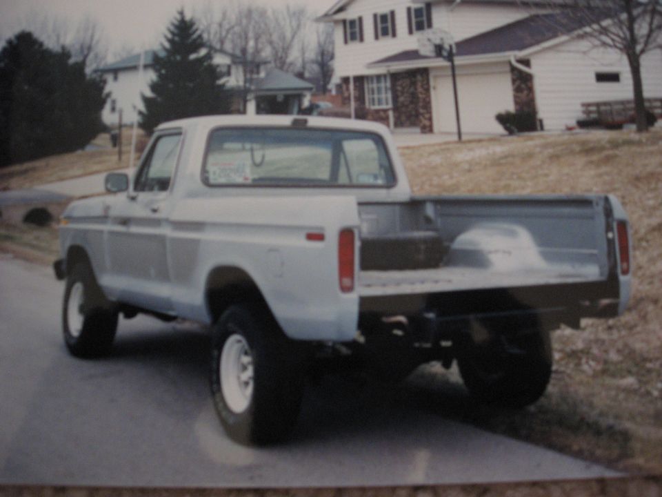 Light-colored 1977 Ford F-150 pickup truck, rear view