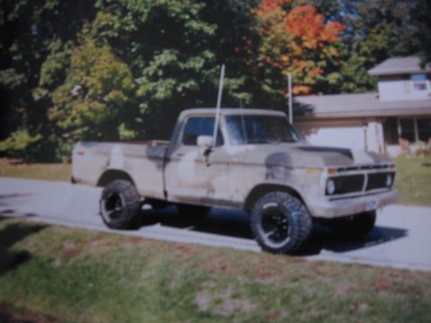 1977 Ford F-150 - This 1977 Ford F-150 pickup truck features camouflage paint and is parked on a residential street.
