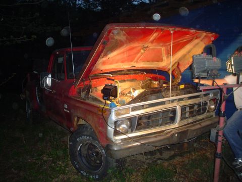 1976 Ford F-100 - This truck appears to be a 1975 Ford F-100, not a 1976 model, with its engine accessible for work.