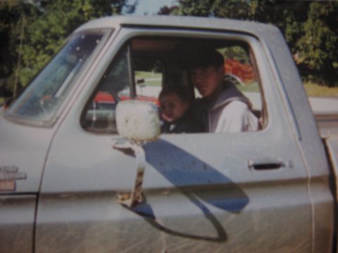 1977 Ford F-150 - A man and a child sit inside a 1977 Ford F-150 pickup truck.