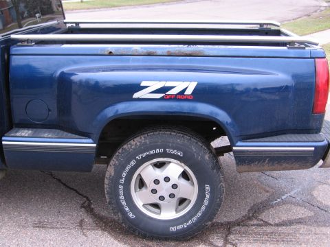 1995 GMC Sierra 1500 - Side view of a blue pickup truck bed a Z71 Off Road decal and BFGoodrich tires.