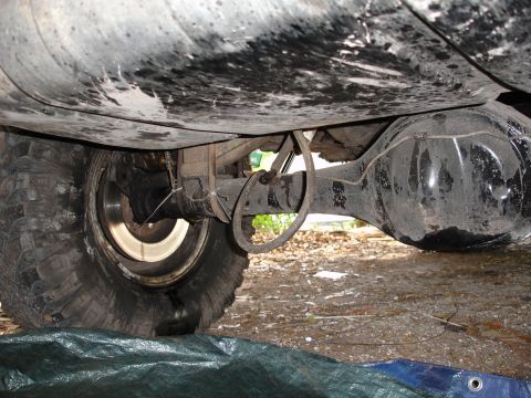 1989 Ford Bronco - Close-up of a vehicle's rear axle and tire assembly, showing suspension components.