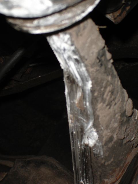 1989 Ford Bronco - Close view of a corroded metal part, likely from a vehicle's suspension system.