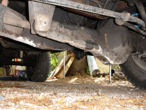 1989 Ford Bronco - The underside of a vehicle, showing the rear axle, suspension, and drivetrain components.