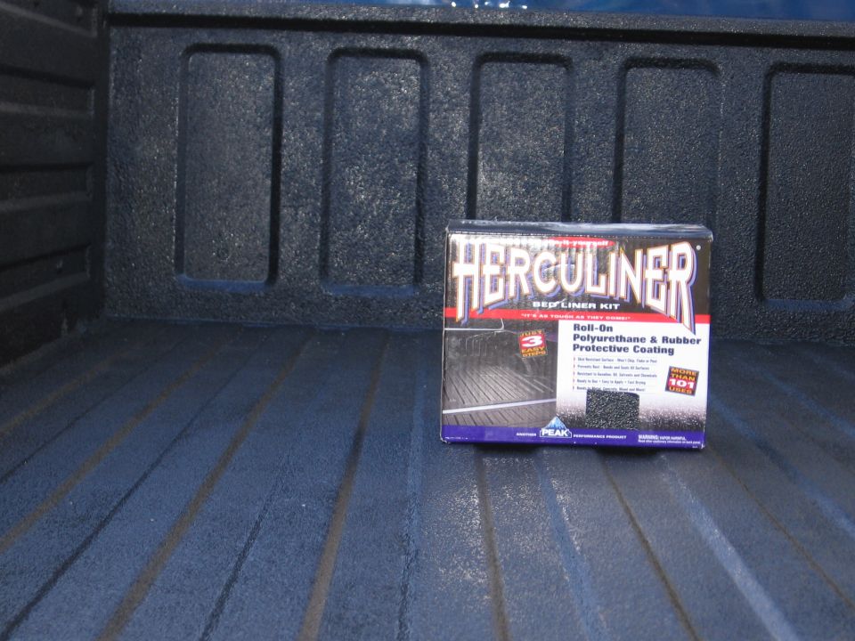 Herculiner bed liner kit box sits in a textured truck bed