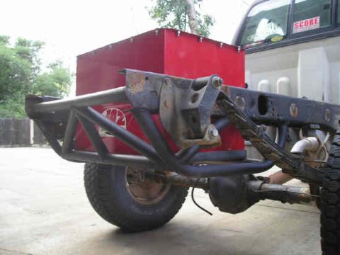 2002 Ford F-150 - Custom rear bumper and fuel tank assembly on a truck chassis, with a SCORE sticker visible on the rear window.