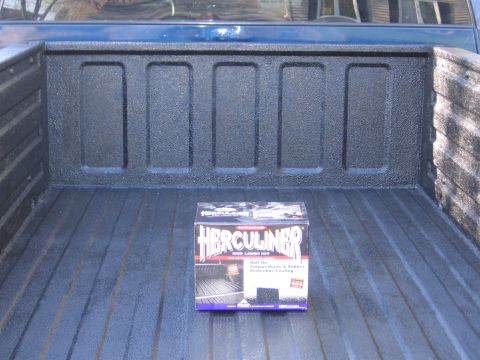 1995 GMC Sierra 1500 - Herculiner bed liner kit box placed inside a truck bed with a textured spray-on liner.