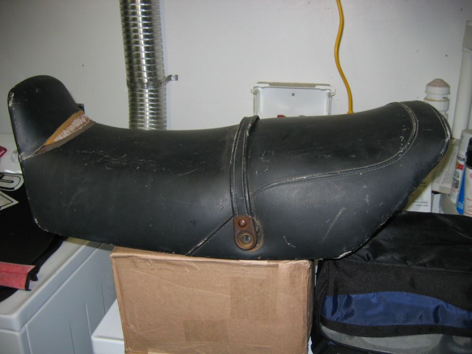 Black motorcycle seat with a leather strap