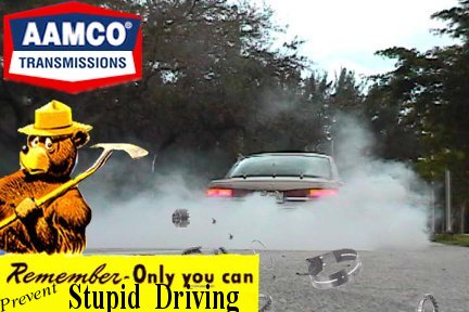 2000 Ford Crown Victoria - Smokey Bear warns against stupid driving with a car performing a burnout, accompanied by AAMCO and Supermotors logos.