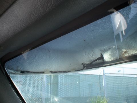 1993 Ford C-350 (Centurion Conversions) - Interior view of a vehicle's visor, showing the textured headliner and a glimpse of the exterior through the windshield.