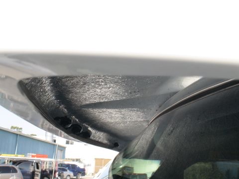 1993 Ford C-350 (Centurion Conversions) - Underside of a vehicle's moonvisor, showing three small lights and textured material.